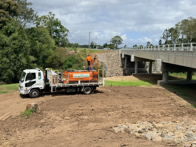 EHM truck working at bridge abutment for erosion control