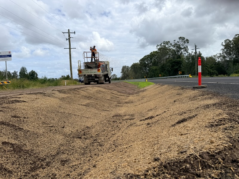Hydromulch being sprayed on roadside intersection